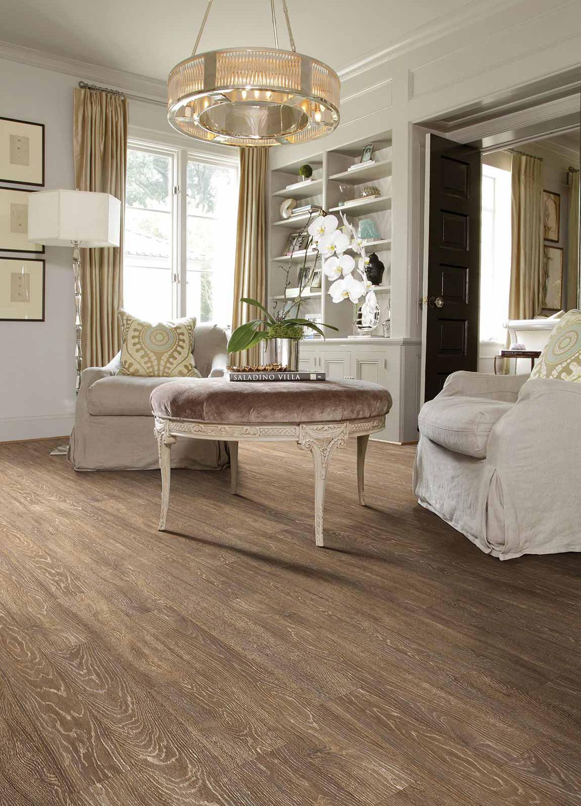 Laminate flooring design featuring oak shaded floors, white furnishings and a chandelier.